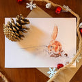 A5 seasonal greeting card of a hand drawn fox running in snow with a kraft envelope