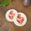 Two round ceramic coasters featuring a detailed illustration of a fluffy red silkie chicken, displayed on a rustic wooden tabletop.